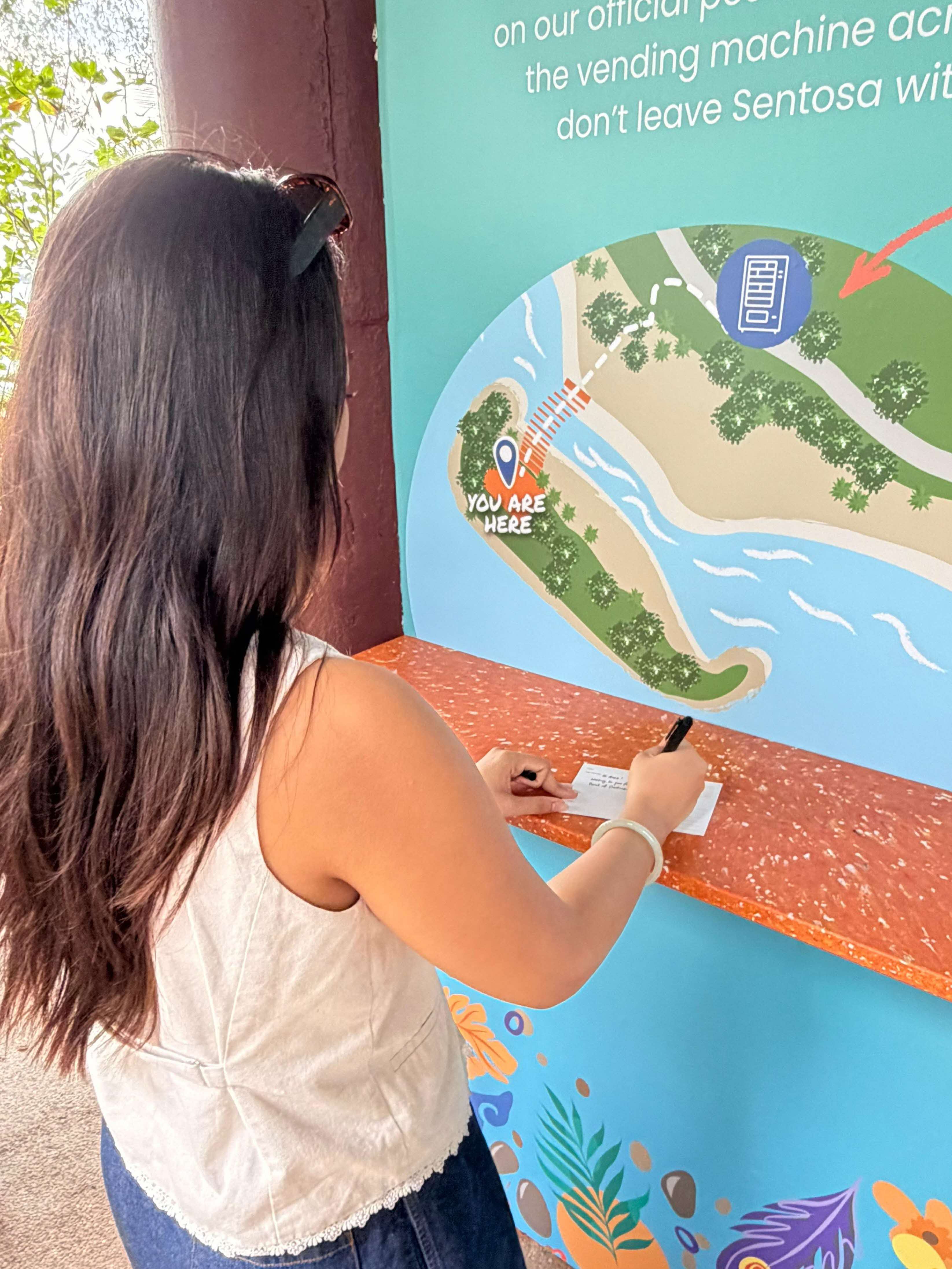 Lady writing on table against board